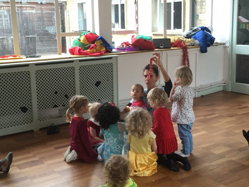 Children gather around Mona at diddi dance