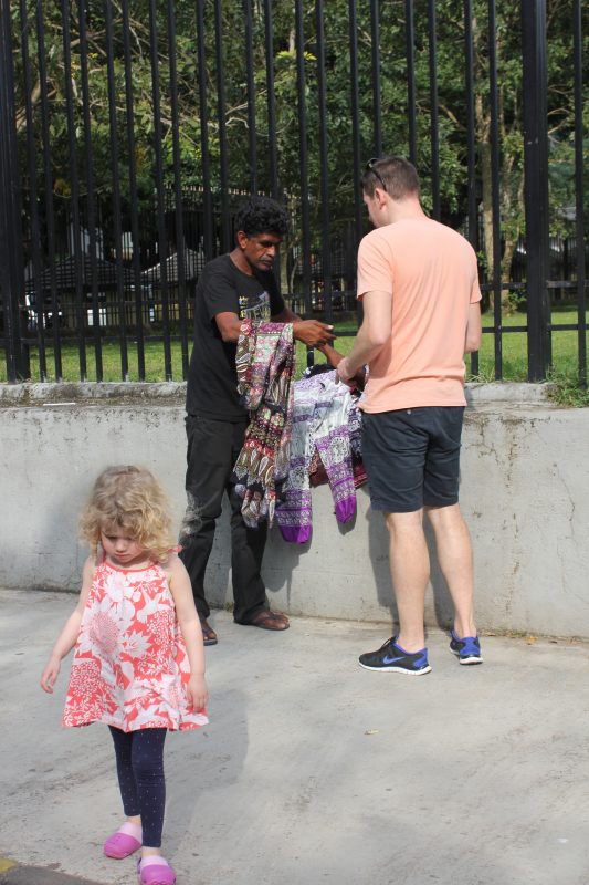 Buying a sarong outside Temple of the Tooth, Kandy, Sri Lanka