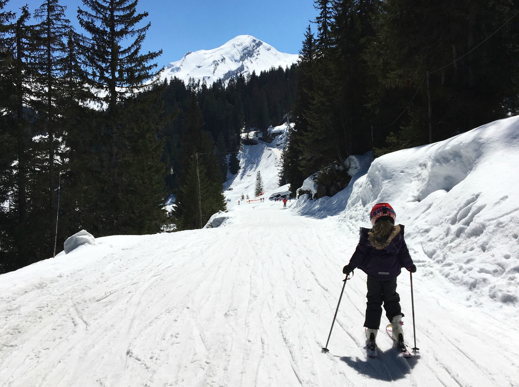 Child skiing on a slope in Morzine during a family ski holiday: Guide to skiing with kids